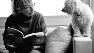 Mary Oliver reading next to dog